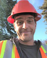 Portrait of Alex Ewing outside wearing a hard hat and safety vest